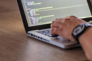 photo of someone coding at a laptop