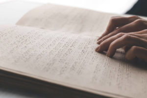 Embossed braille page being read