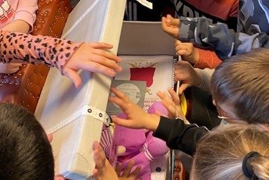 Photo of children engaging with a box of resources