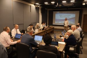 photo of the DAISY board members gathered around a table with laptops 