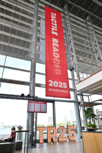 photo from the Tactile Reading 2025 event showing a branded banner